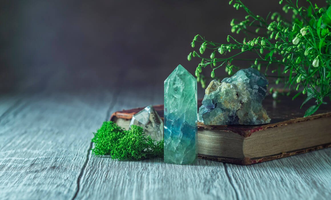 Green_crystal_on_old_book_on_table